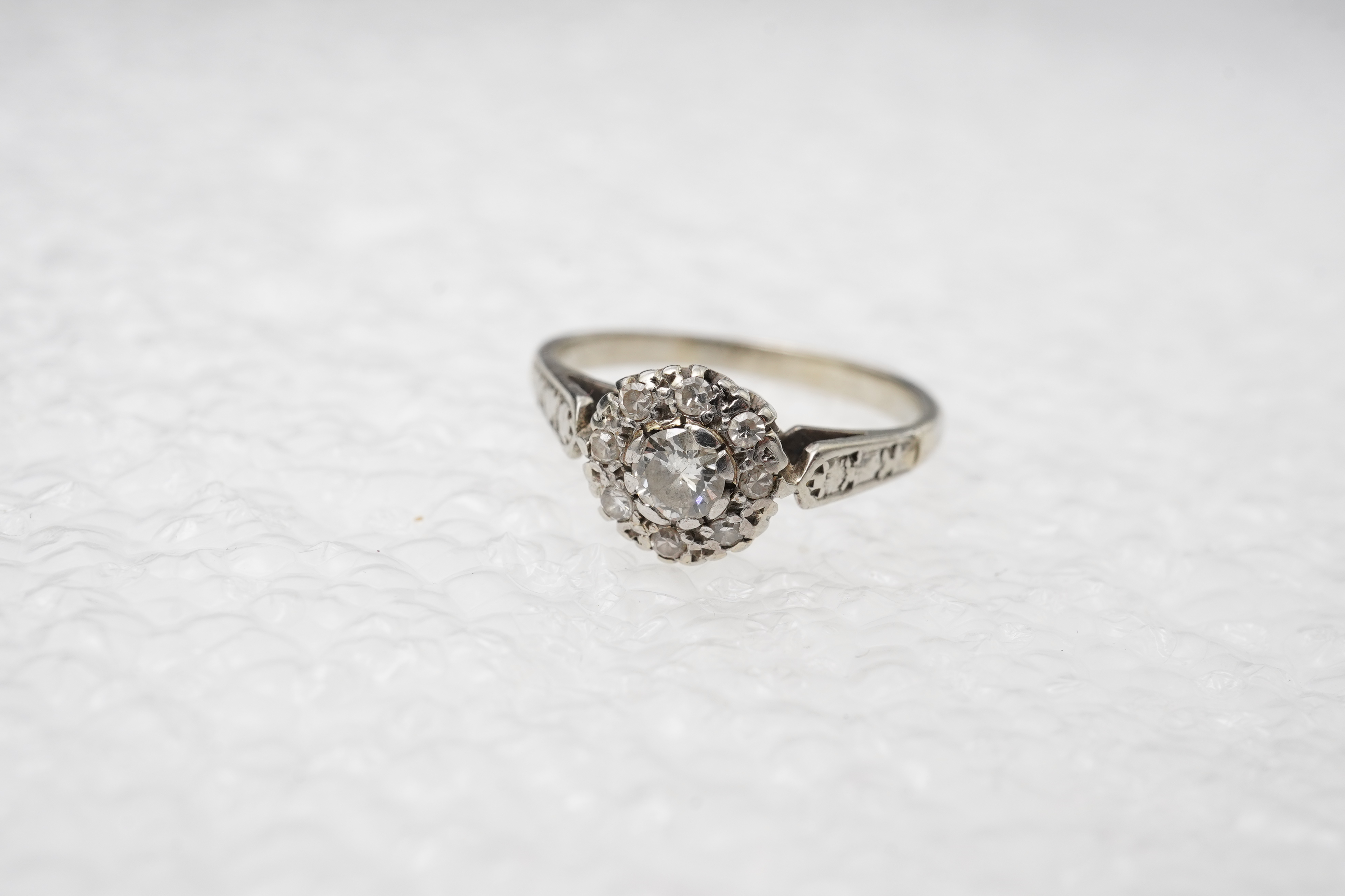 A diamond cluster ring, mid 20th century, set with a cluster of brilliant-cut diamonds totalling approximately 0.30 carats, mounted in unmarked white metal, size G, gross weight approximately 3 grams